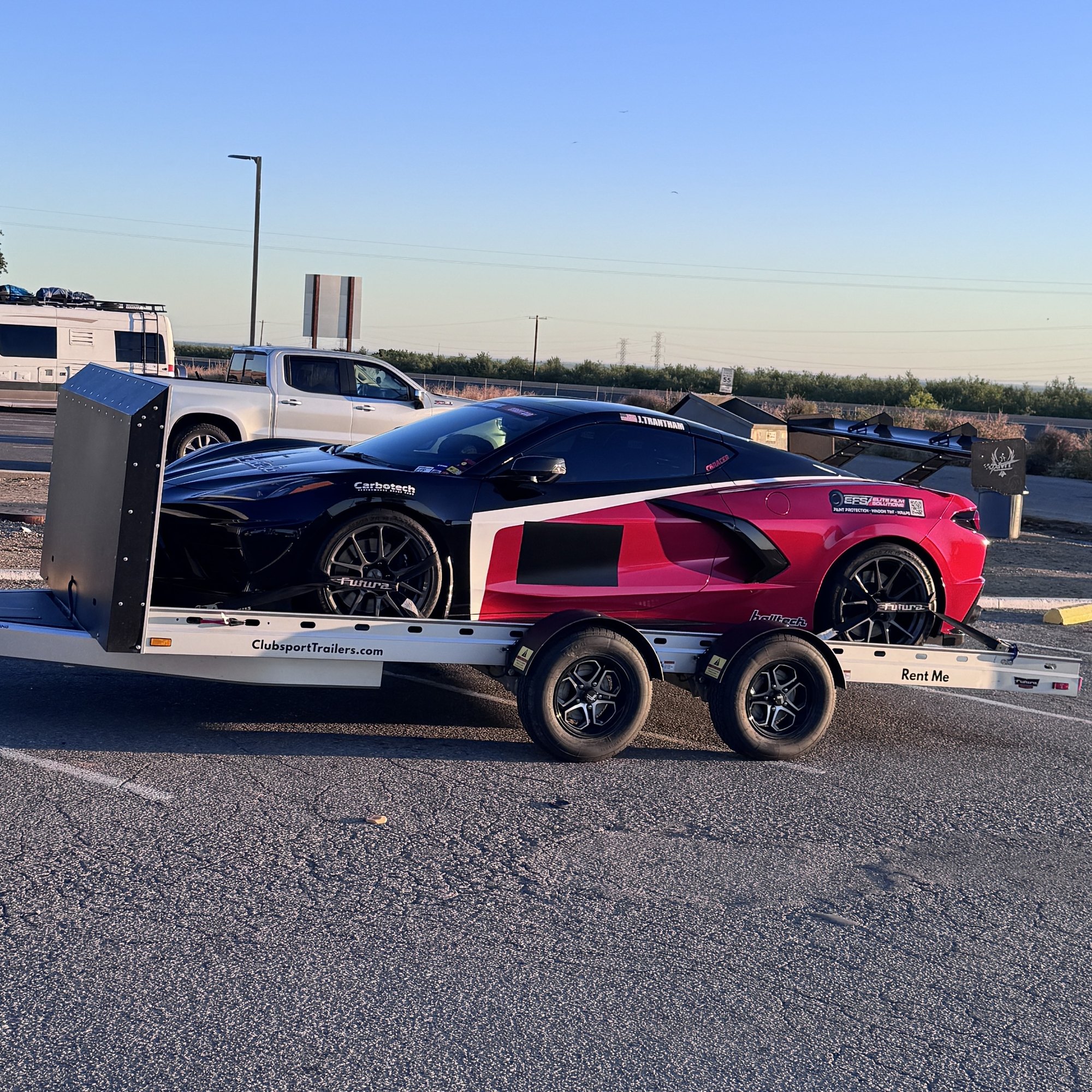 Sports car loaded on the Club Sport Futura trailer at the track at sunset
