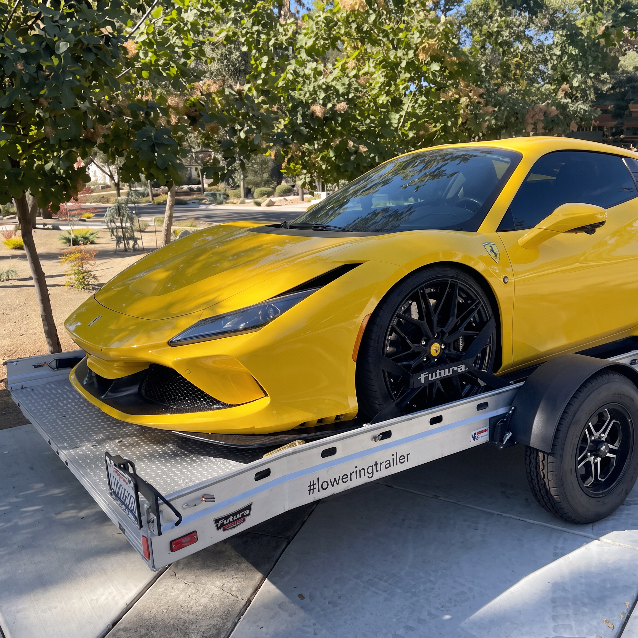 Yellow Ferrari secured on the Club Sport Futura lowering car trailer